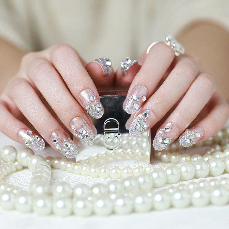 Sparkling artificial nails with rhinestones and sparkling accents Bowlift