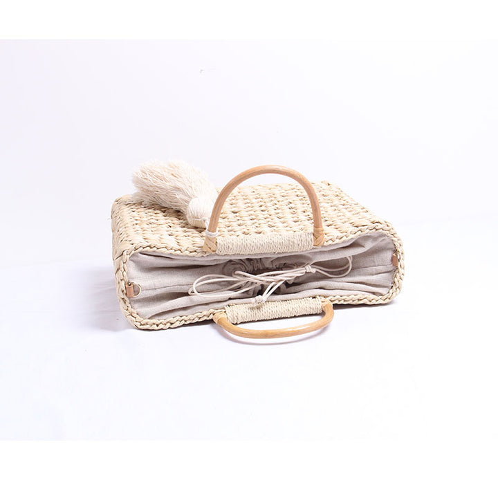 Handcrafted straw shoulder bag with decorative tassel pendant Bowlift