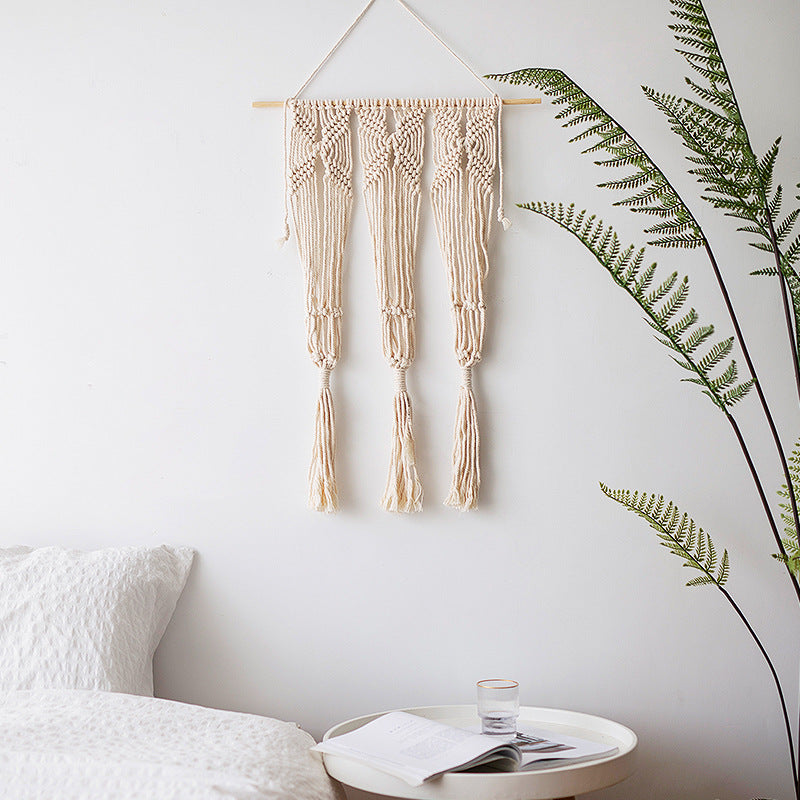 Macramé wall hanging with geometric triple tassel design and wooden rod Bowlift