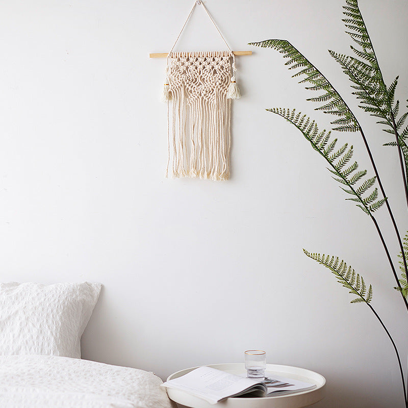 Macramé wall hanging with geometric triple tassel design and wooden rod Bowlift