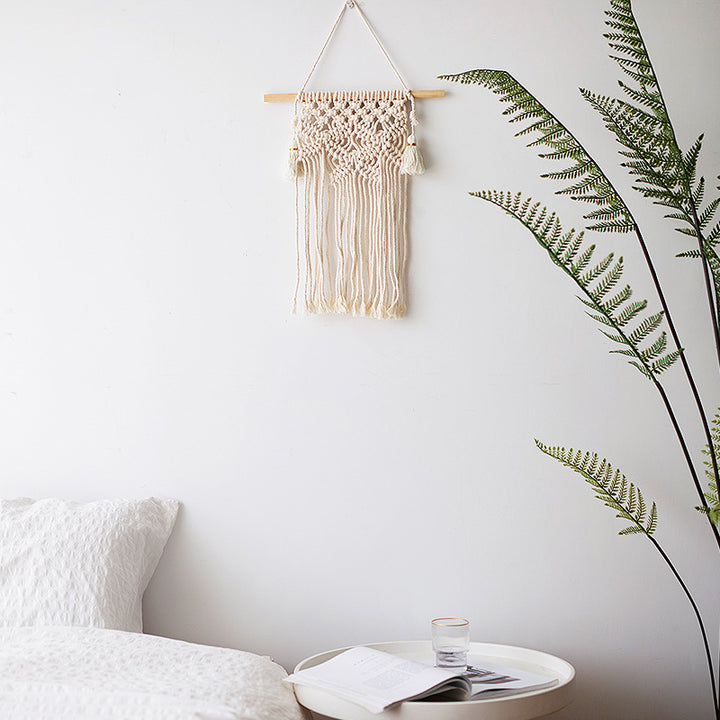 Macramé wall hanging with geometric triple tassel design and wooden rod Bowlift
