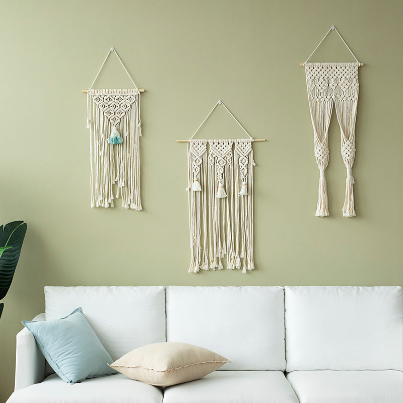 Macramé wall hanging with geometric triple tassel design and wooden rod Bowlift