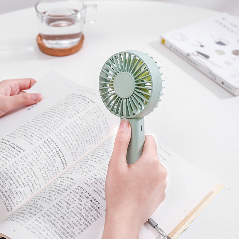 Unisex portable battery-operated mini hand fan with one-button operation and protected fan grill Bowlift
