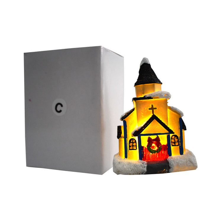 Illuminated Christmas house made of resin with snow effect