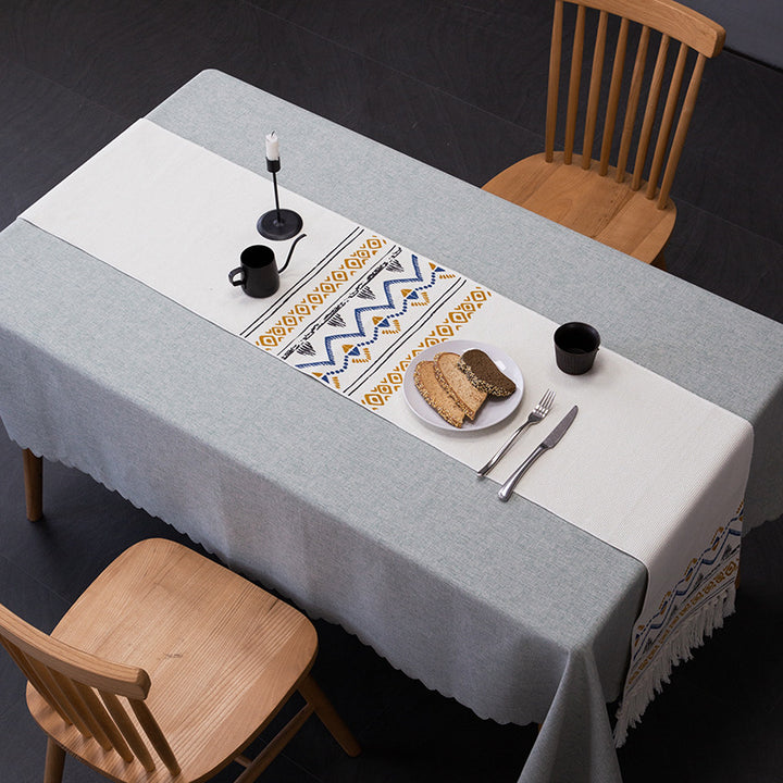 Woven table runner with fringes and ethnic chevron pattern
