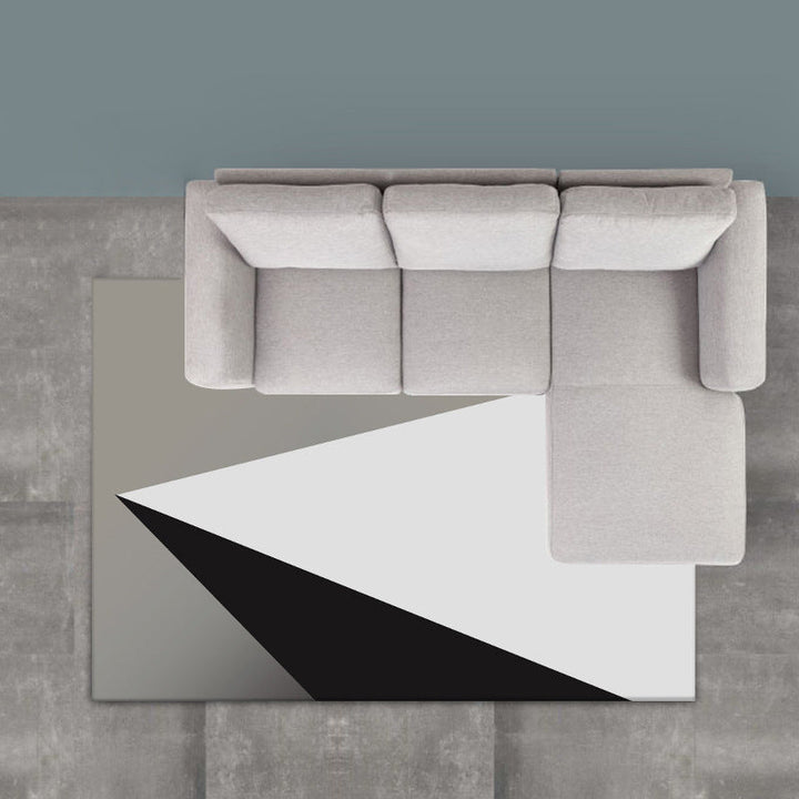 Modern living room rug in gray and white, color block triangle print, rug made of polyester, washable area rug | Bowlift