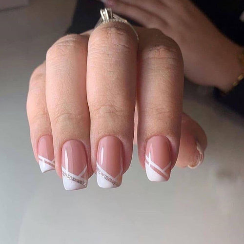 Artful nail design with elegant French tip and glitter accents Bowlift