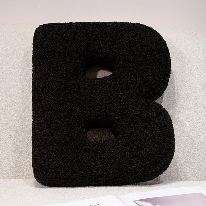 Plush cuddle pillow with letter and heart motifs