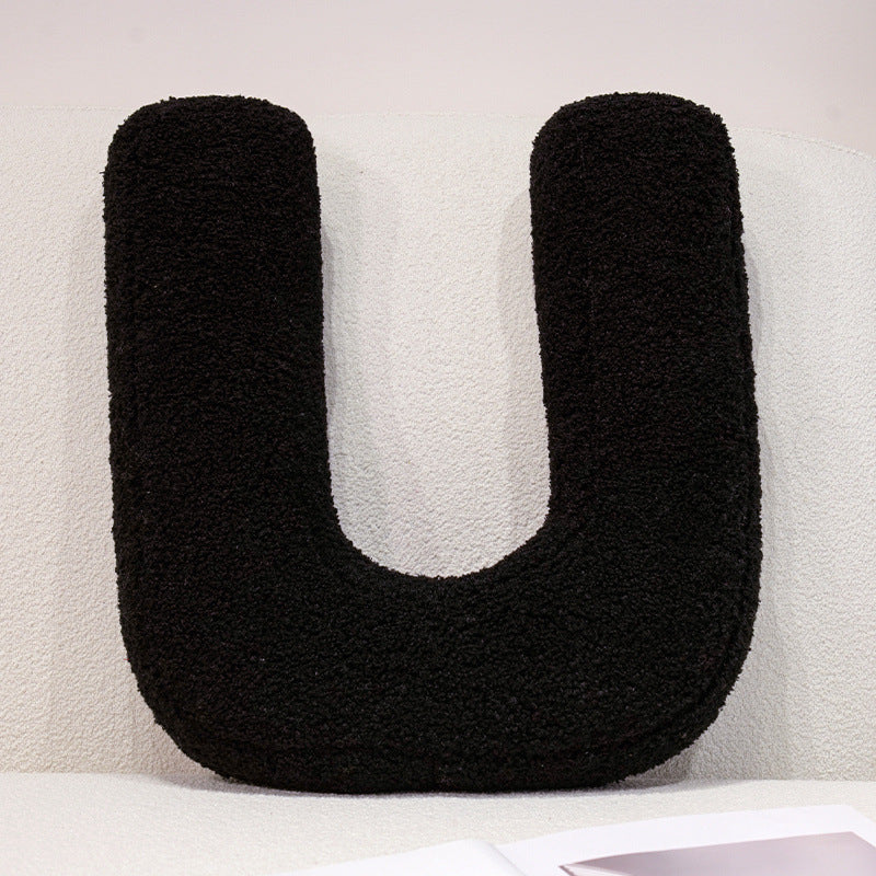 Plush cuddle pillow with letter and heart motifs