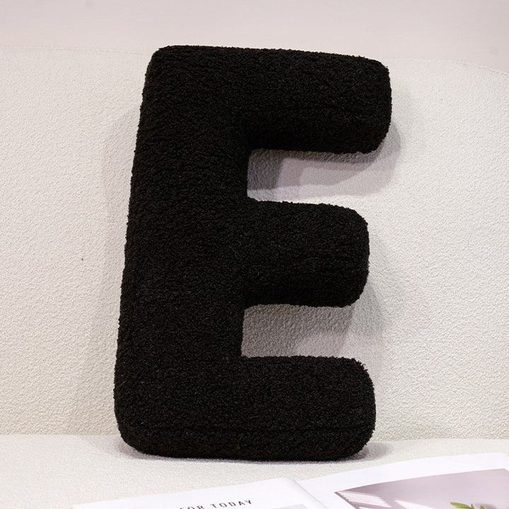 Plush cuddle pillow with letter and heart motifs