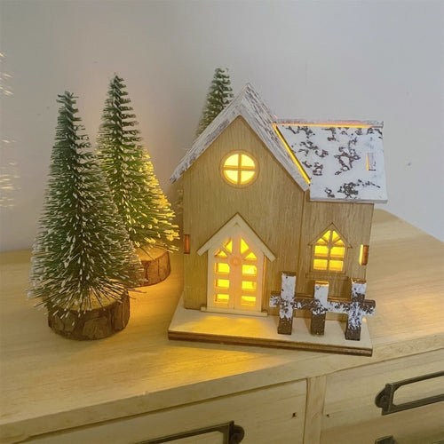 Illuminated Wooden Christmas House with Snow Landscape