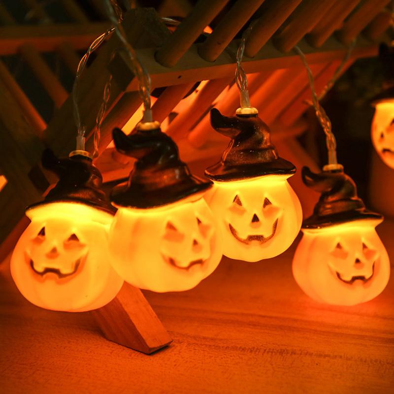 Glowing pumpkin garland Halloween with witch hats | Bowlift