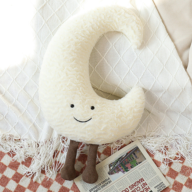 Decorative cuddle cushions with moon, star, and sun motif