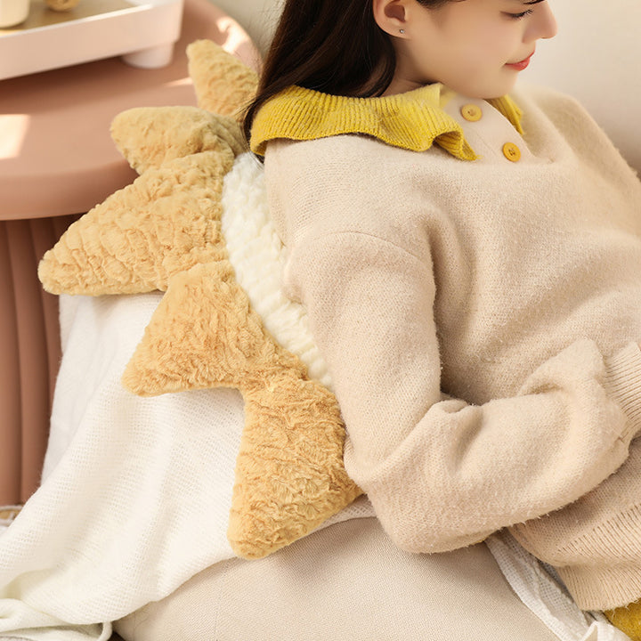 Decorative cuddle cushions with moon, star, and sun motif