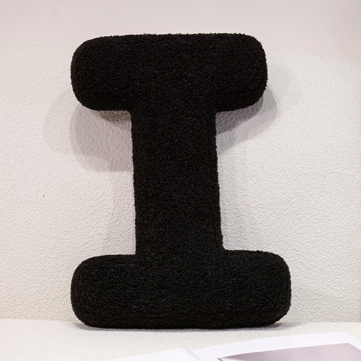 Plush cuddle pillow with letter and heart motifs
