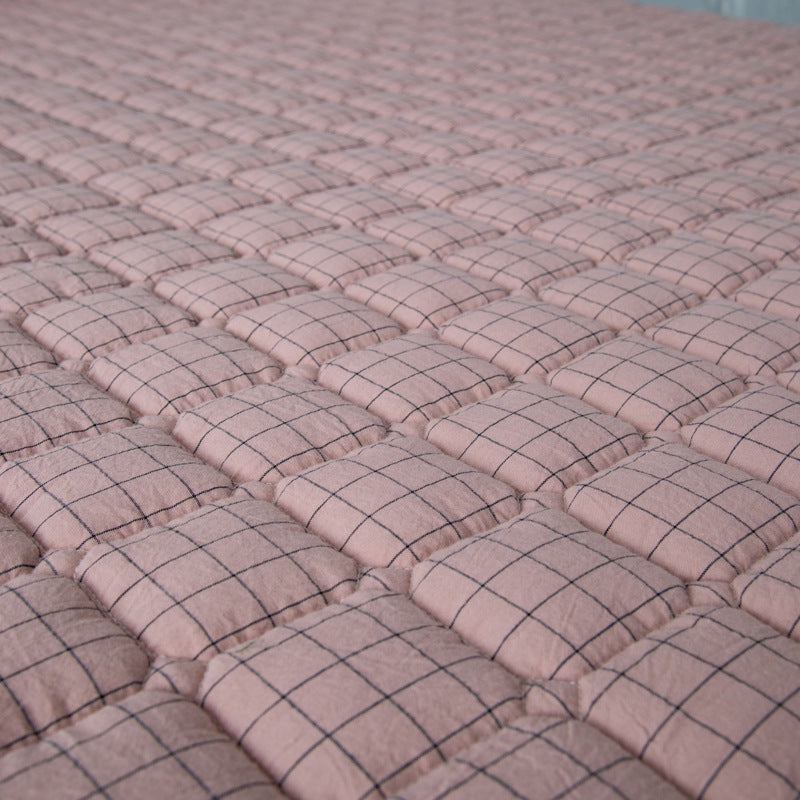 Padded mattress protector-topper with quilting and non-slip underside