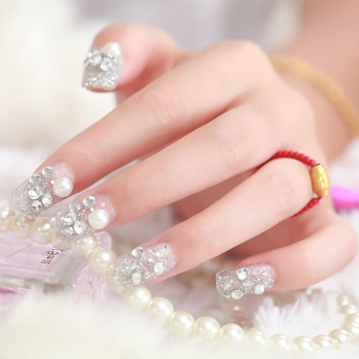 Art nails with glitter and pearl accents Bowlift