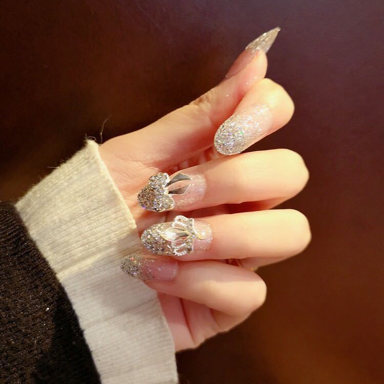 Nail art with sparkling rhinestone and glitter accents Bowlift