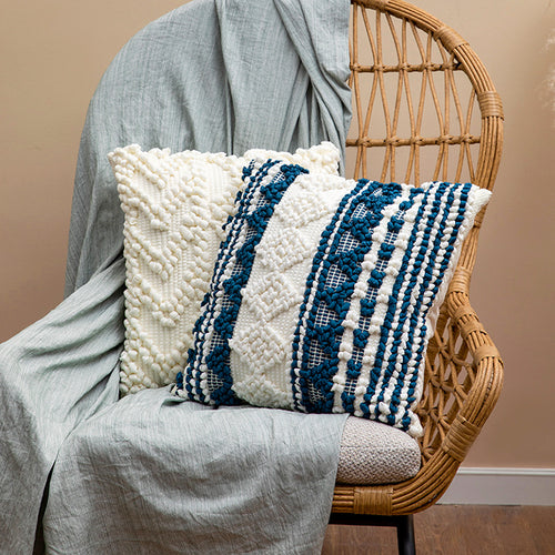 Square woven decorative cushion cover with crocheted appliqués and textured relief