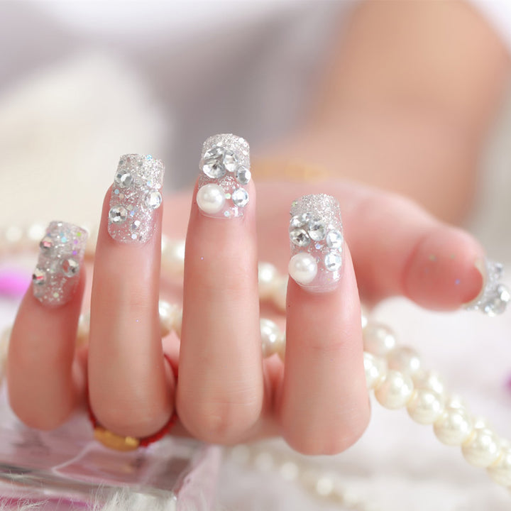 Art nails with glitter and pearl accents Bowlift