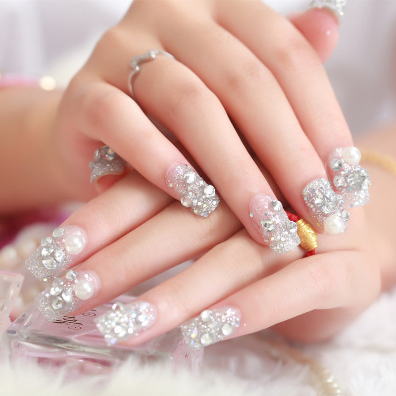 Art nails with glitter and pearl accents Bowlift