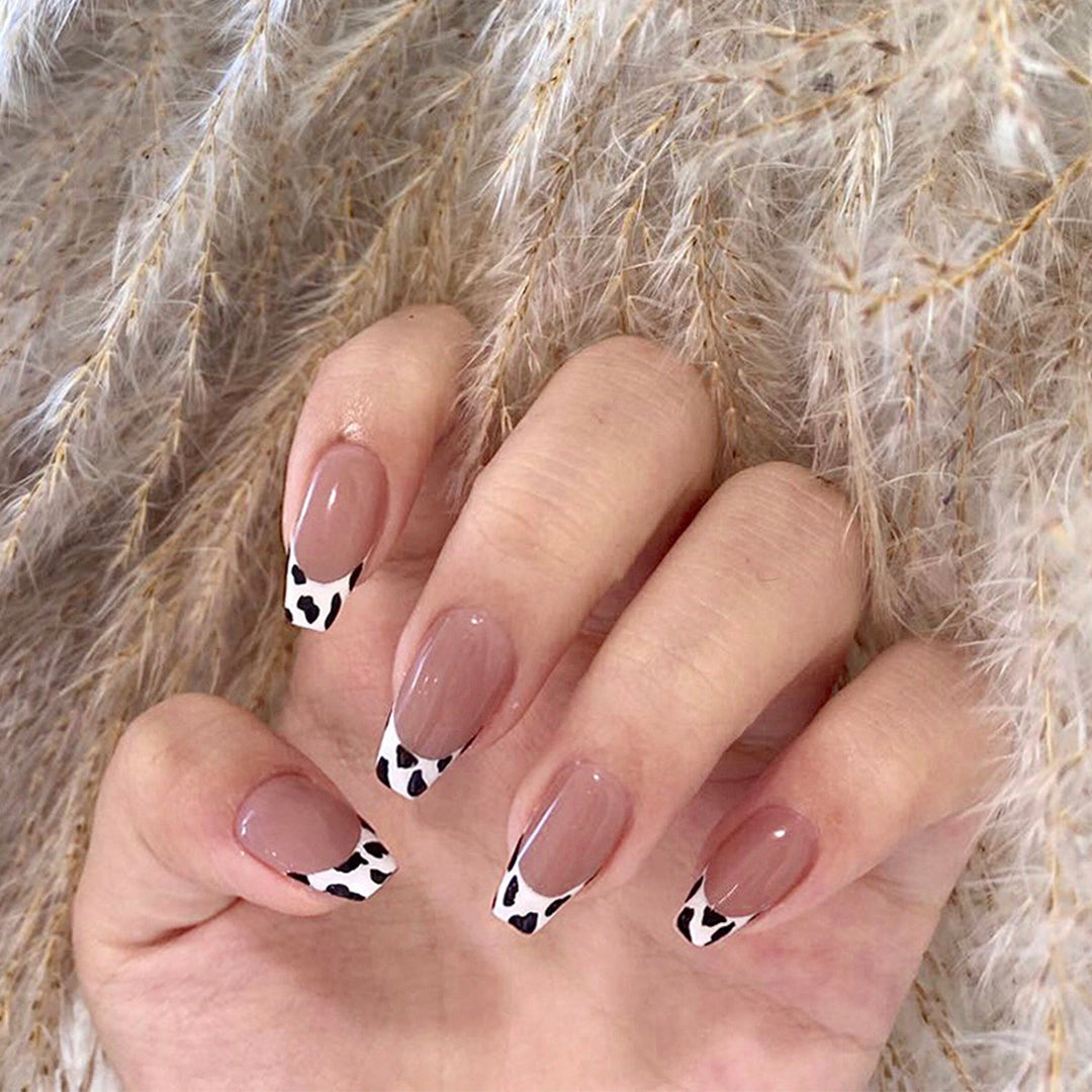Stylish nail extensions in modern cow print style Bowlift