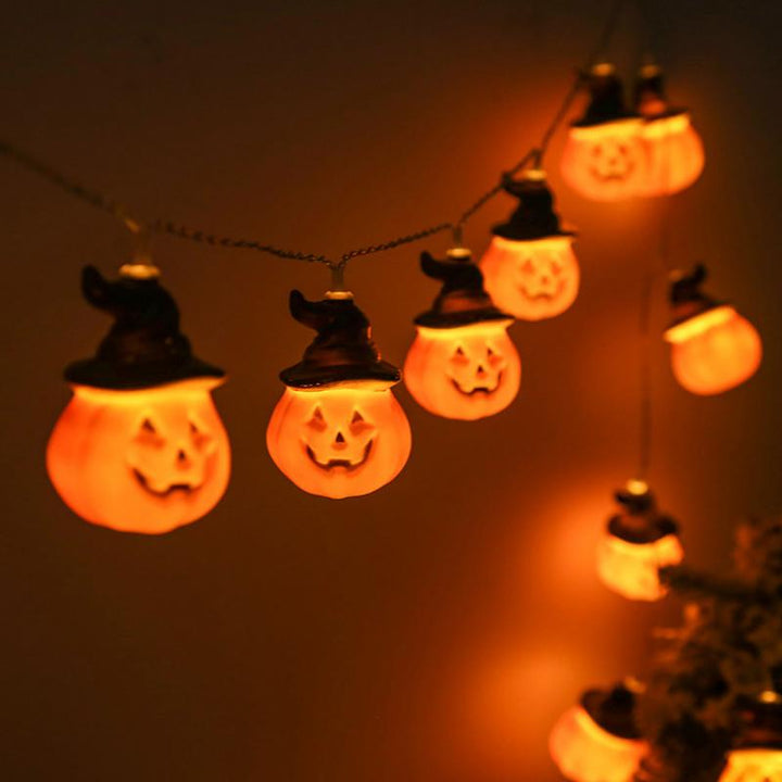 Glowing pumpkin garland Halloween with witch hats | Bowlift