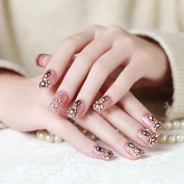 Glamorous artificial nails with glitter and jewelry decoration Bowlift