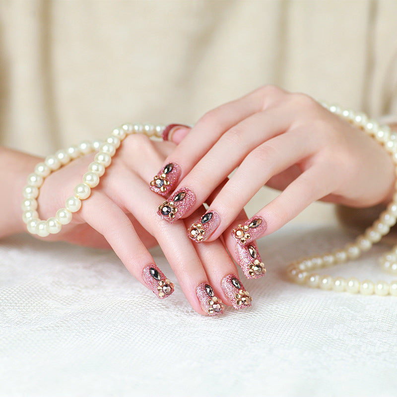 Glamorous artificial nails with glitter and jewelry decoration Bowlift