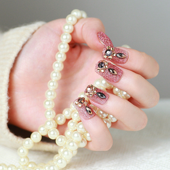 Glamorous artificial nails with glitter and jewelry decoration Bowlift