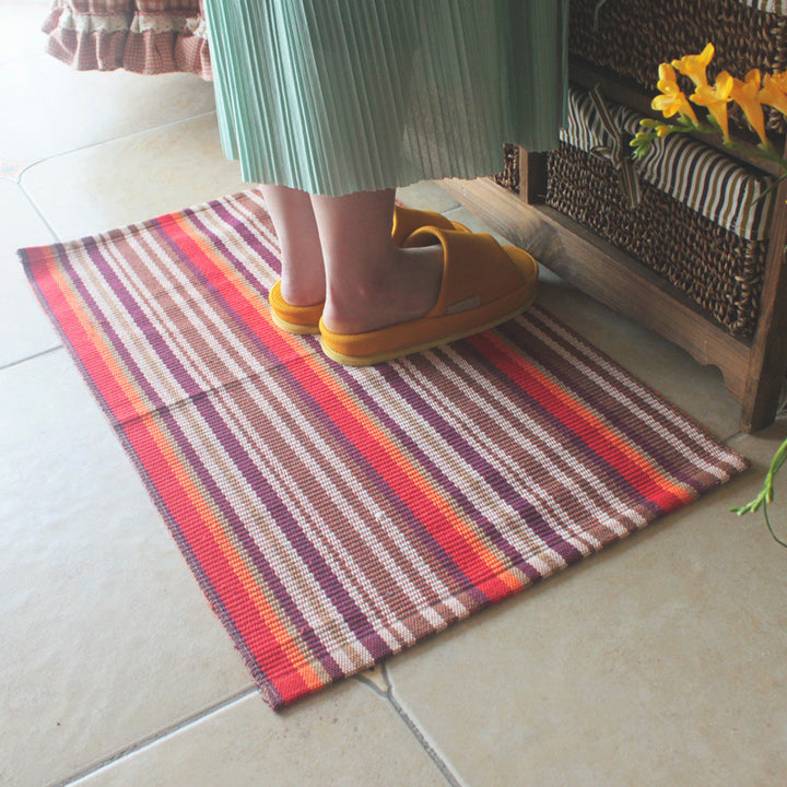 Woven colorful table runner with fringes and checkered structure