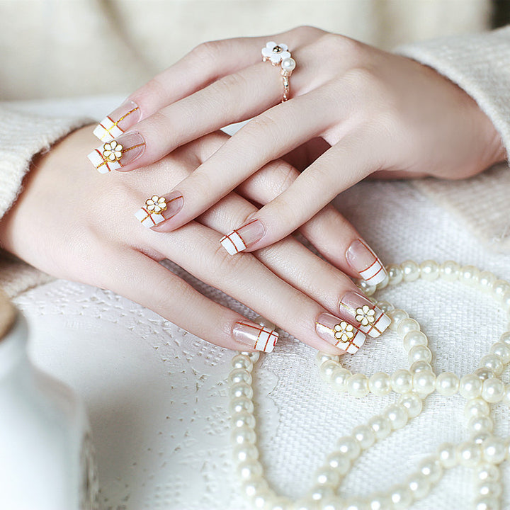 Artificial nails with elegant 3D flower accents and gold trim Bowlift