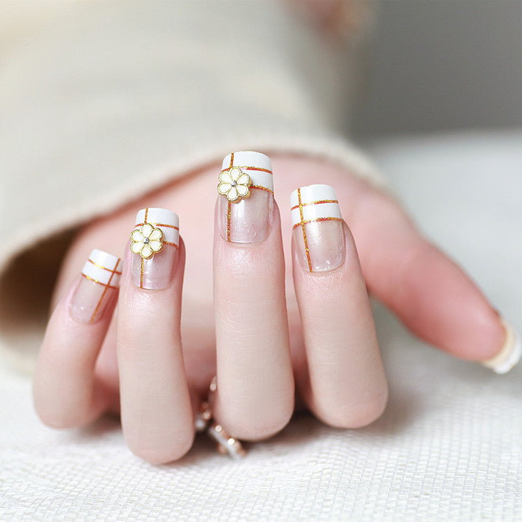 Artificial nails with elegant 3D flower accents and gold trim Bowlift