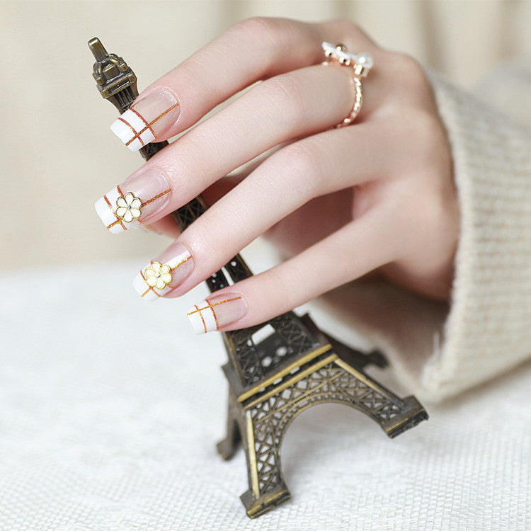 Artificial nails with elegant 3D flower accents and gold trim Bowlift