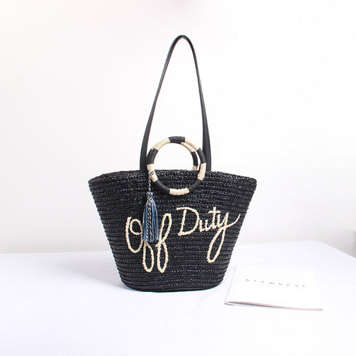 Designer shoulder bag with playful lettering and decorative tassel detail Bowlift