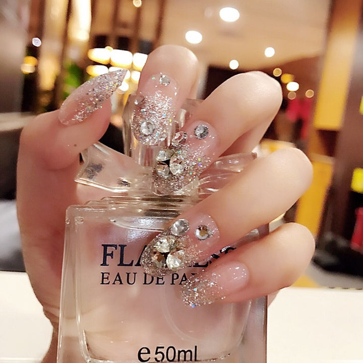 Sparkling artificial nails with rhinestones and sparkling accents Bowlift