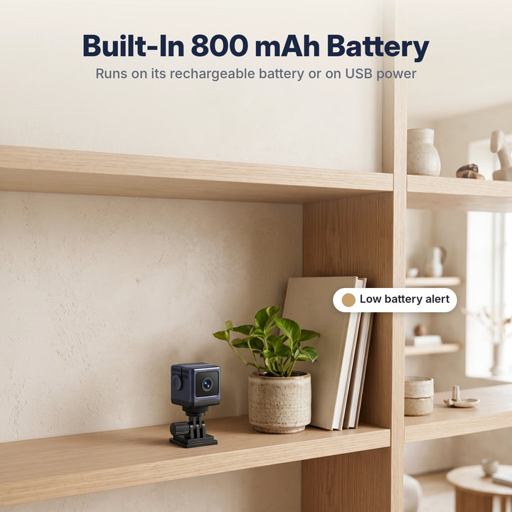 Battery-powered mini camera on a bookshelf with low battery alert