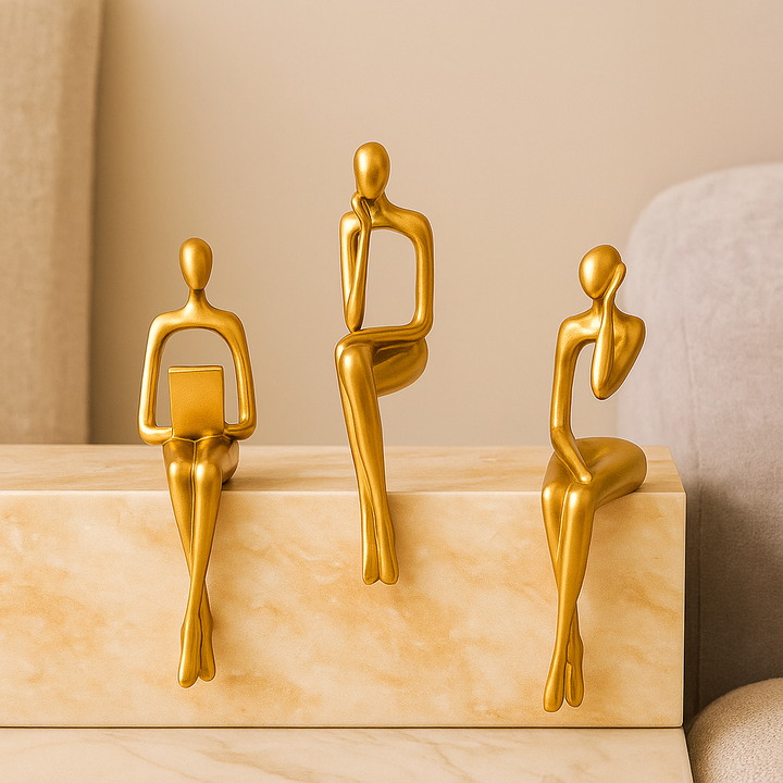 Golden abstract thinker statues in unique artistic positions Bowlift
