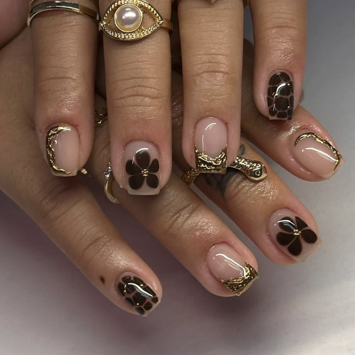 Artistic Nail Art with Elegant Golden Accents Bowlift