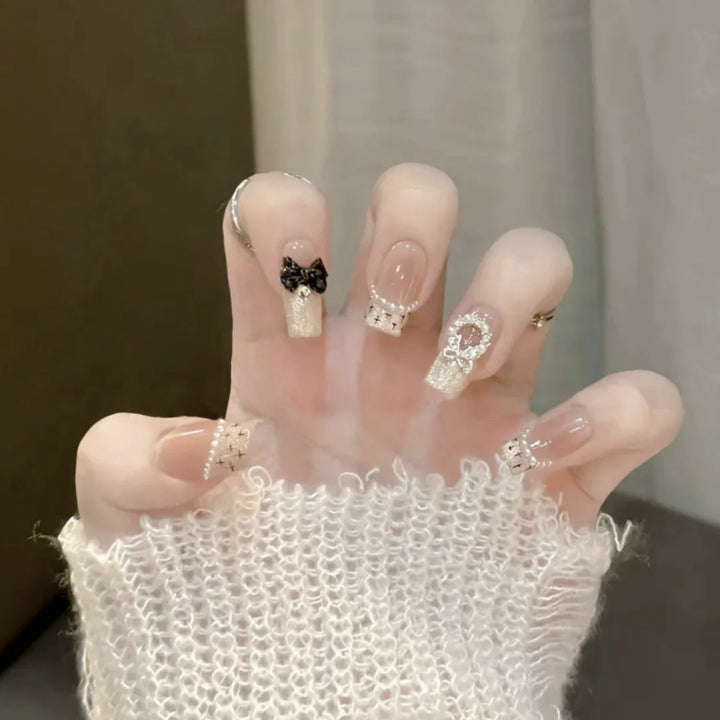 Glamorous artificial nails with sparkling decorations Bowlift