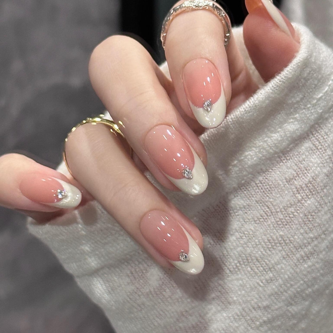Artificial nails with elegant French style and sparkling accents Bowlift