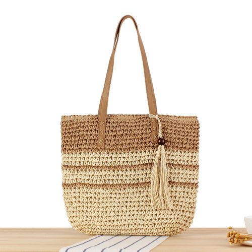 Handbag made of braided natural material with decorative tassel pendant Bowlift