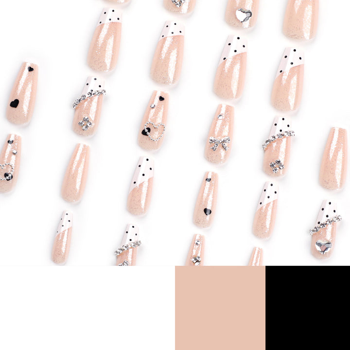 Artful nail extensions with elegant rhinestone and heart designs Bowlift