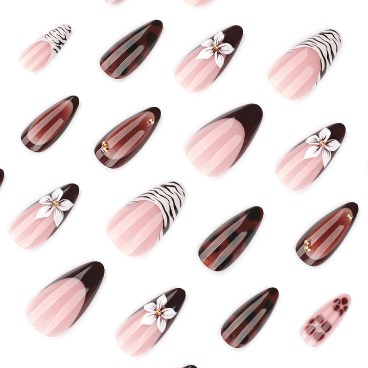 Artistic stiletto nails with elegant floral designs and glitter accents Bowlift