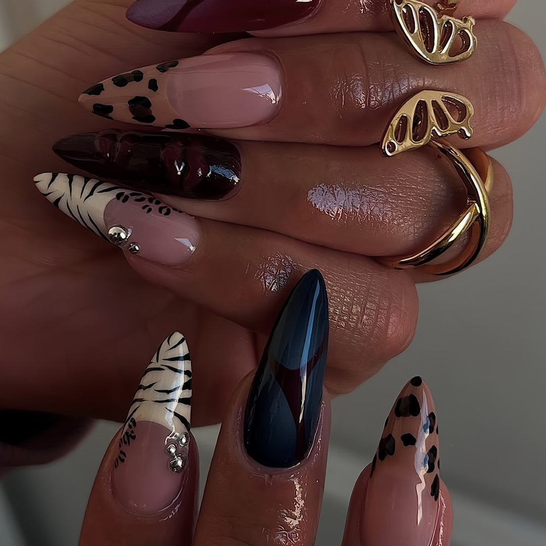 Artistic Stiletto Nail Enhancements with Trendy Animal Print and Gem Accents Bowlift