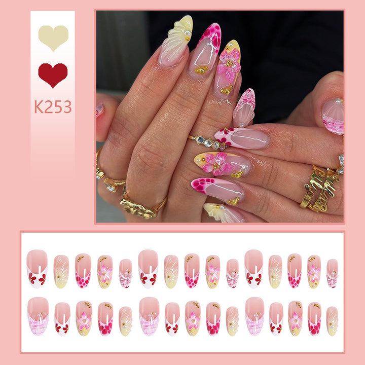 Artificial nails with floral accents and glitter decorations Bowlift