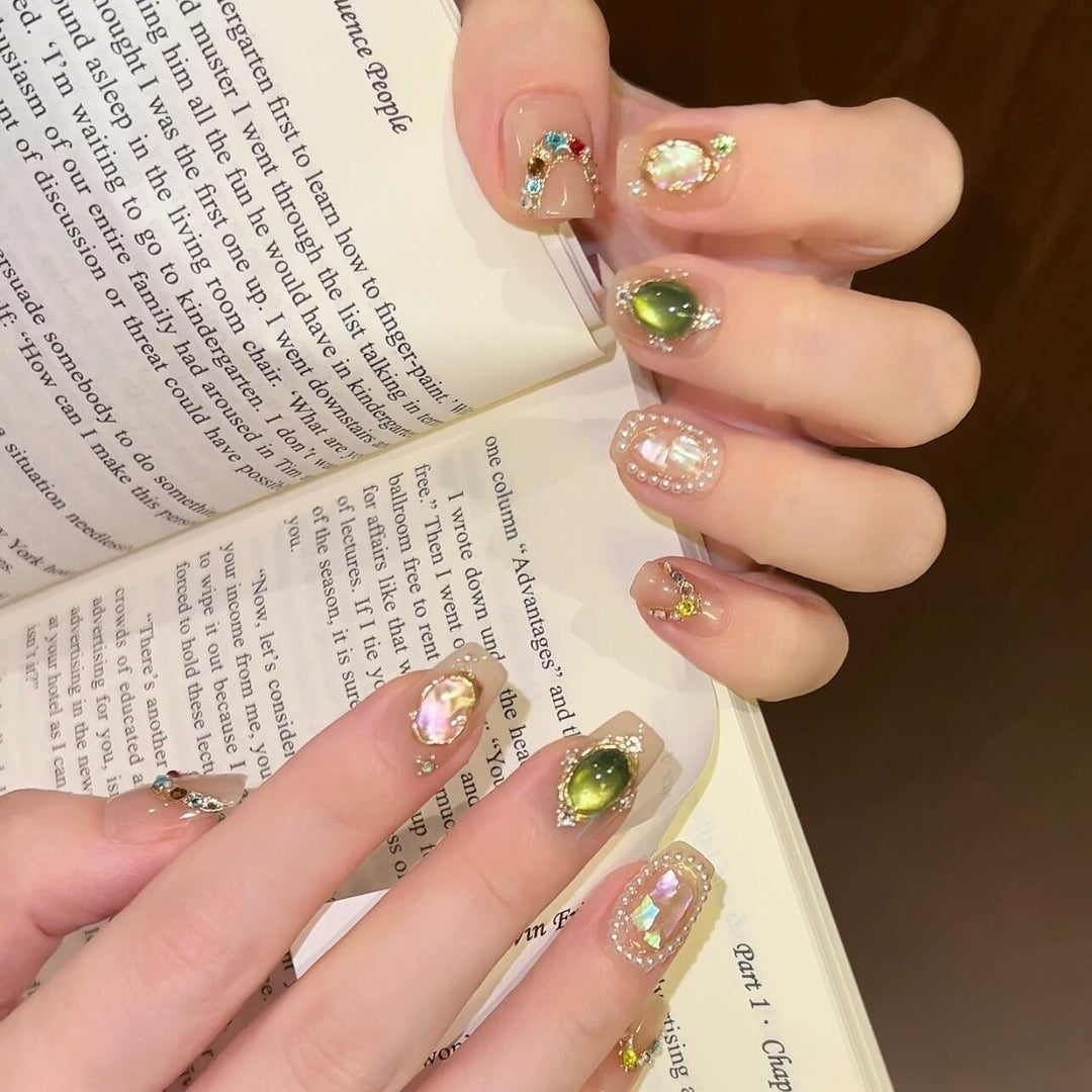 Artificial nails with rhinestone and pearl accents Bowlift