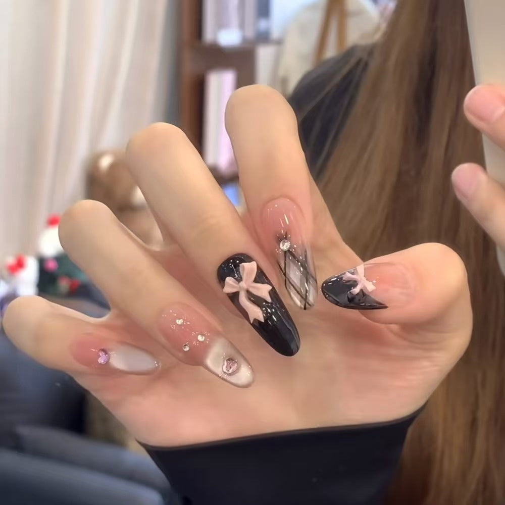 Artificial nails with playful bow design and glitter effects Bowlift