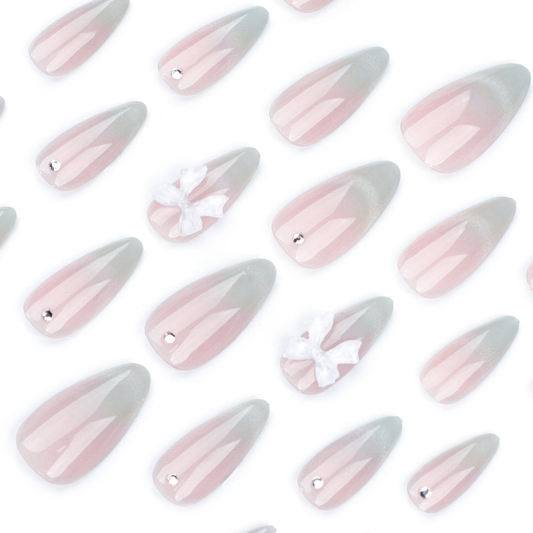 Elegant Stiletto Nails with Glitter and Bow Accents Bowlift