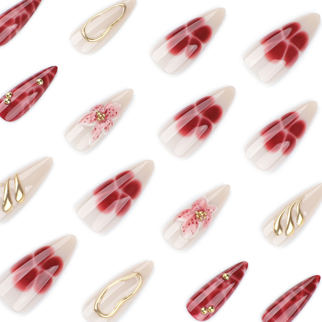 Artful stiletto nails with elegant floral designs and glitter accents Bowlift